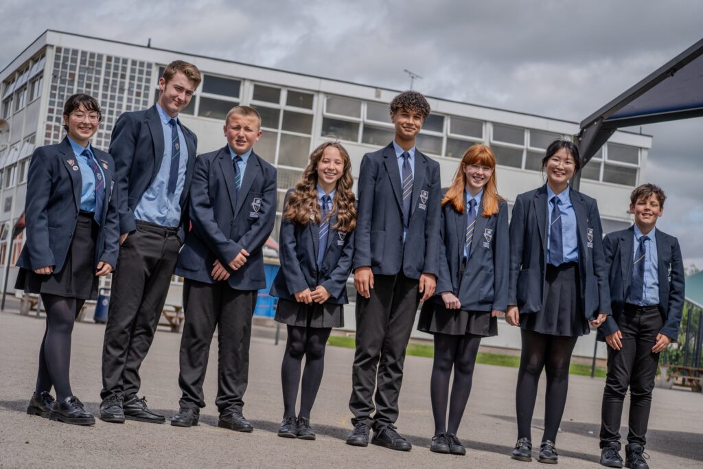 Group of Church of England secondary school students standing together outdoors